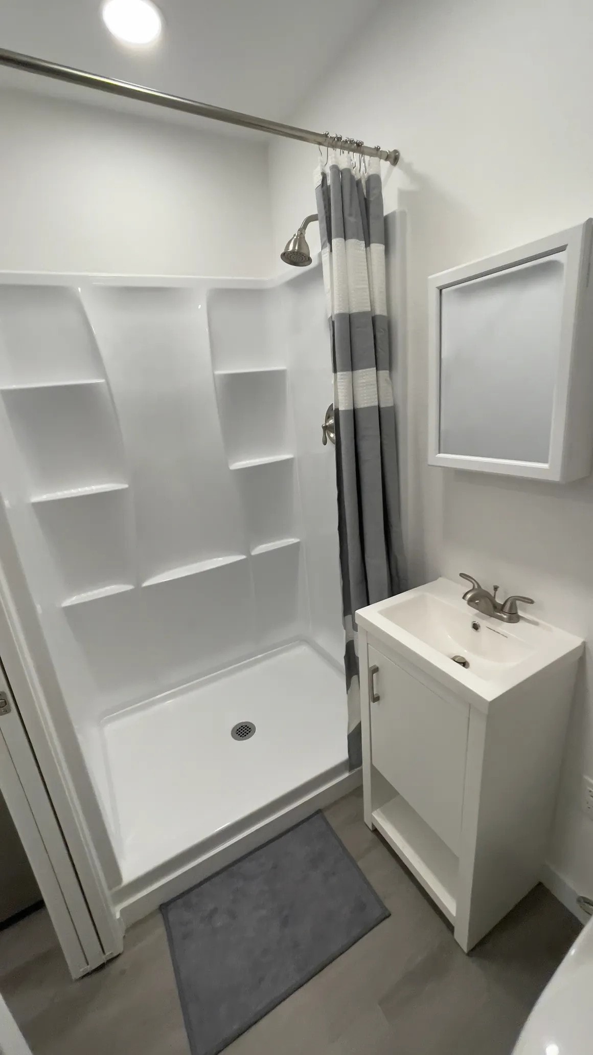 Container home interior with orange door and wood ceiling